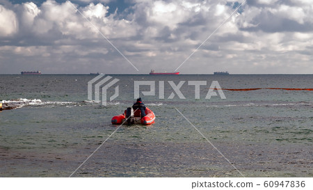 A red rubber coast guard rescue boat with a A red rubber coast guard rescue boat with a 60947836