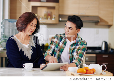 Man visiting mother at home 60947883