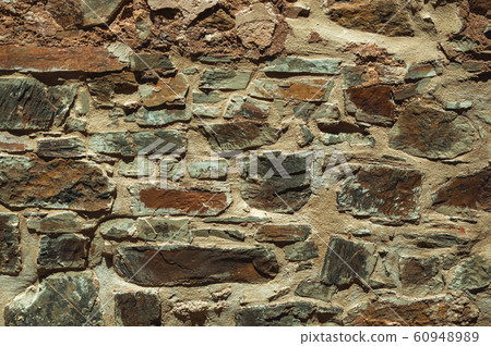 Old wall made of rough stones Old wall made of rough stones 60948989
