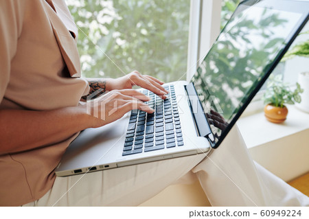 Young woman working on laptop at home 60949224