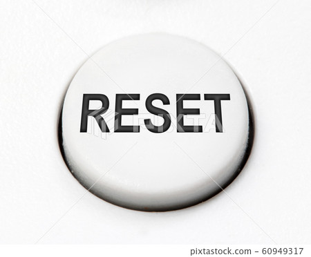 A white round button switch for reset close up. A white round button switch for reset close up. 60949317