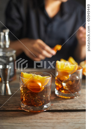 Tasty alcoholic old fashioned cocktail with orange Tasty alcoholic old fashioned cocktail with orange 60949449