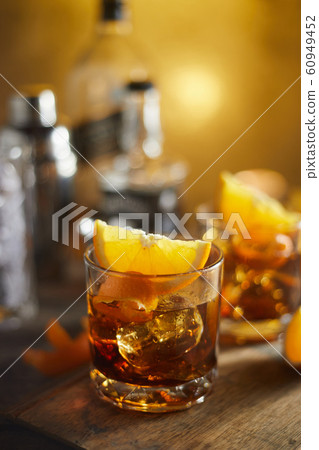 Tasty alcoholic old fashioned cocktail with orange Tasty alcoholic old fashioned cocktail with orange 60949452