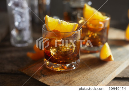 Tasty alcoholic old fashioned cocktail with orange 60949454