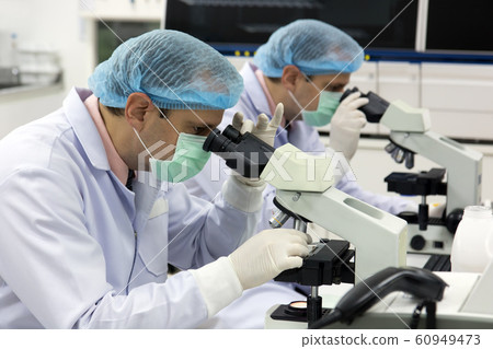 Team of researchers working in a laboratory with Team of researchers working in a laboratory with 60949473