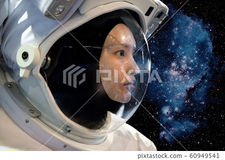 Astronaut woman on space mission with stars on the Astronaut woman on space mission with stars on the 60949541