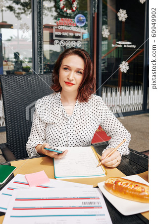 Business lady at outdoor cafe table Business lady at outdoor cafe table 60949902