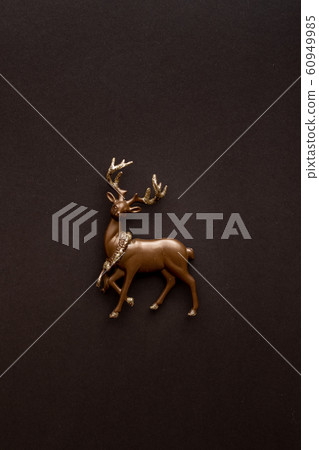 Miniature deer on a dark background with copy 60949985