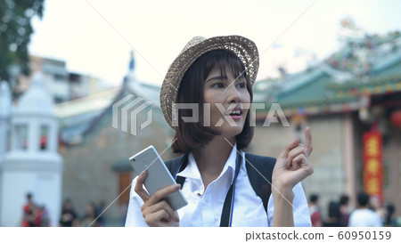 Travel concept. Beautiful women are playing mobile Travel concept. Beautiful women are playing mobile 60950159