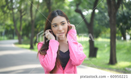 Holiday concept. Asian girl is enjoying listening 60950221