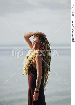 Pretty woman with flower necklace 60950731