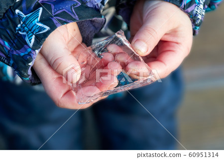 frozen ice in the hands of a child frozen ice in the hands of a child 60951314