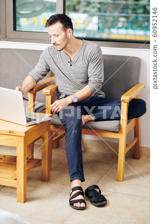 Young man checking his e-mails 60952146