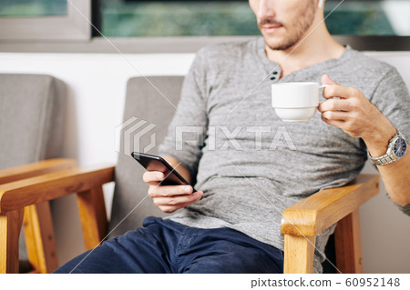 Man checking smartphone Man checking smartphone 60952148