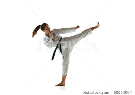 Confident junior in kimono practicing hand-to-hand combat, martial arts 60953004