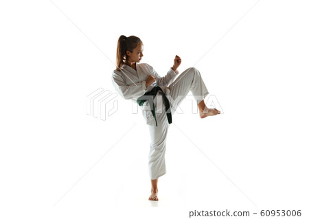 Confident junior in kimono practicing hand-to-hand combat, martial arts Confident junior in kimono practicing hand-to-hand combat, martial arts 60953006