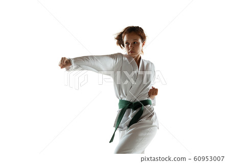Confident junior in kimono practicing hand-to-hand combat, martial arts 60953007