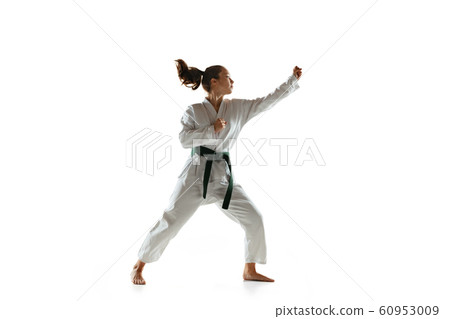 Confident junior in kimono practicing hand-to-hand combat, martial arts 60953009