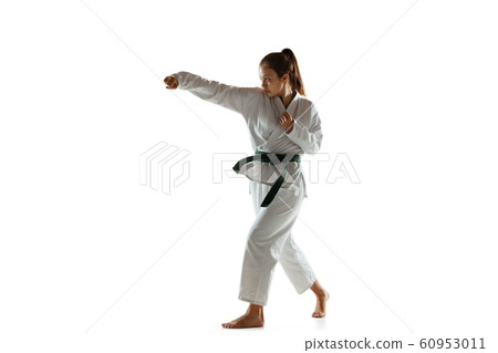 Confident junior in kimono practicing hand-to-hand combat, martial arts 60953011