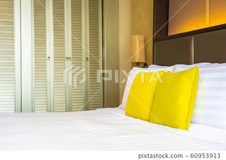 Pillow and blanket on bed with light lamp decoration interior 60953913