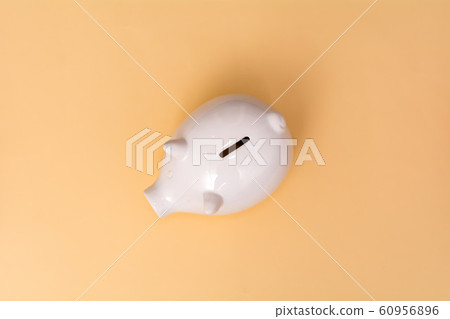 White pig piggy bank on a beige background.  60956896
