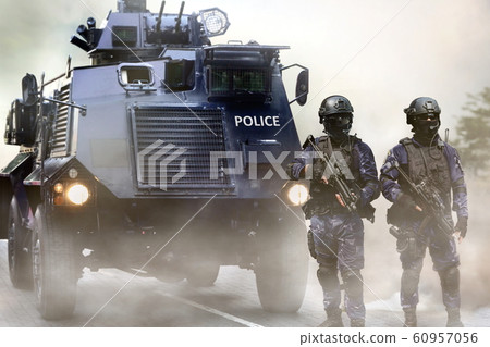Police special force on standby infront of the armored vehicles during special opps 60957056