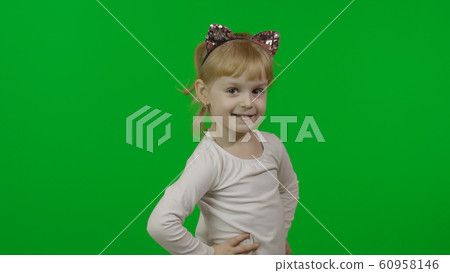 Girl in cat headband looks at camera and smile. Happy four years old child Girl in cat headband looks at camera and smile. Happy four years old child 60958146