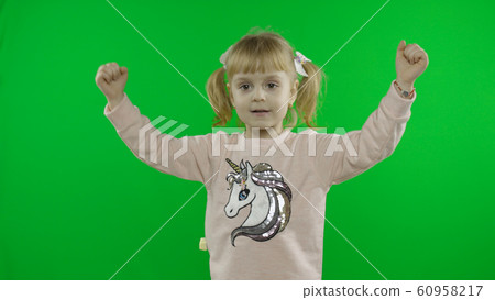 Girl in unicorn sweatshirt dancing. Happy four years old child. Chroma Key 60958217