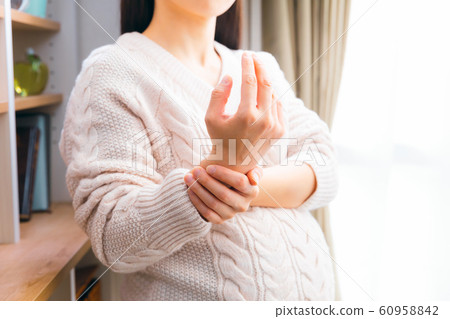 Pregnant woman holding wrist various symptoms 60958842