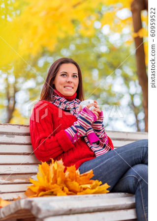 Young pretty woman walking in an autumn fall park Young pretty woman walking in an autumn fall park 60959522