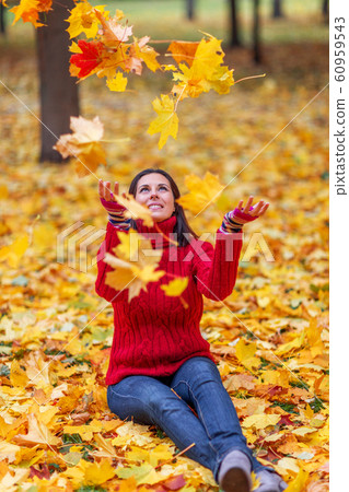 Young pretty woman walking in an autumn fall park Young pretty woman walking in an autumn fall park 60959543
