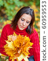 Young pretty woman walking in an autumn fall park 60959553