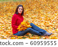 Young pretty woman walking in an autumn fall park 60959555