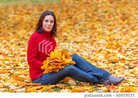 Young pretty woman walking in an autumn fall park Young pretty woman walking in an autumn fall park 60959555