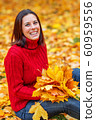 Young pretty woman walking in an autumn fall park 60959556