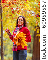 Young pretty woman walking in an autumn fall park 60959557