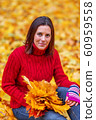 Young pretty woman walking in an autumn fall park 60959558