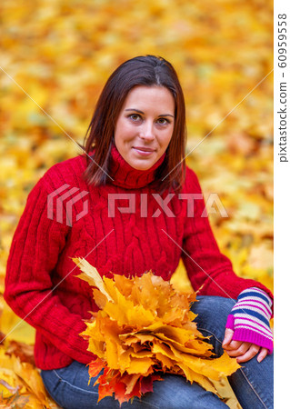 Young pretty woman walking in an autumn fall park Young pretty woman walking in an autumn fall park 60959558