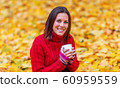 Young pretty woman walking in an autumn fall park 60959559