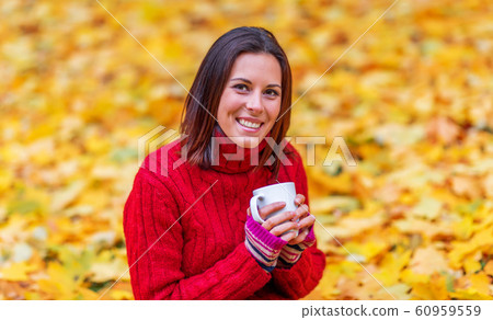 Young pretty woman walking in an autumn fall park Young pretty woman walking in an autumn fall park 60959559