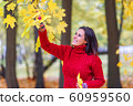 Young pretty woman walking in an autumn fall park 60959560