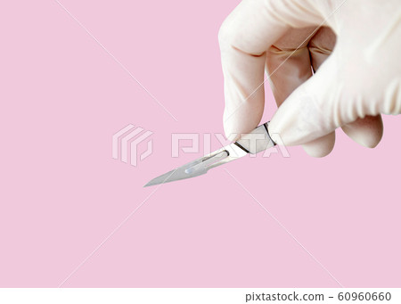 Scalpel or surgical knife in surgeon hand isolated Scalpel or surgical knife in surgeon hand isolated 60960660