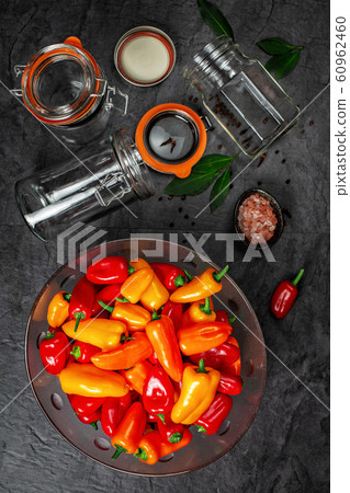 Colourful mini bell peppers and glass bowl Colourful mini bell peppers and glass bowl 60962460