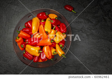 Mix of Colourful mini bell peppers dark bowl Mix of Colourful mini bell peppers dark bowl 60962461