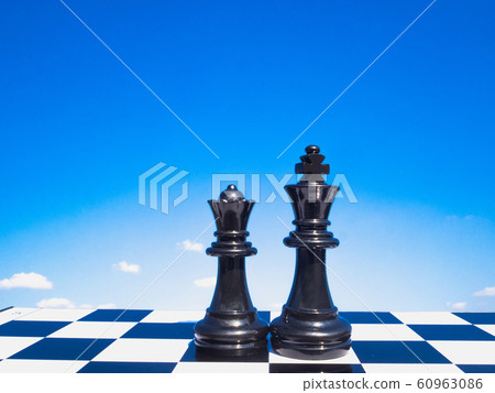 Black king and queen chess are standing on a board with blue sky and white clouds background, Leadership challenges planning business strategy to success concept Black king and queen chess are standing on a board with blue sky and white clouds background, Leadership challenges planning business strategy to success concept 60963086