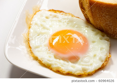Fried egg and bread. Light meal and breakfast image. (White plate, white background) Fried egg and bread. Light meal and breakfast image. (White plate, white background) 60964026