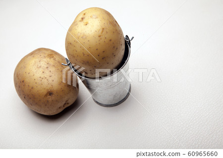 fresh potato bucket white background  60965660