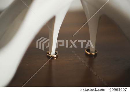 Two golden wedding rings isolated background concept Two golden wedding rings isolated background concept 60965697