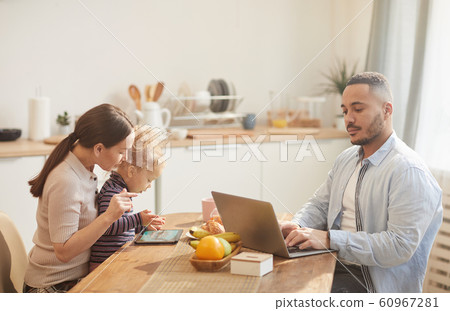 Modern Family Using Gadgets at Breakfast Modern Family Using Gadgets at Breakfast 60967281