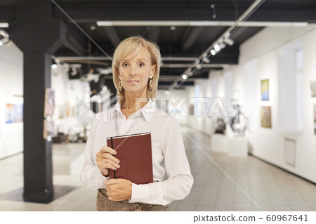 Elegant Art Expert Posing in Gallery Elegant Art Expert Posing in Gallery 60967641